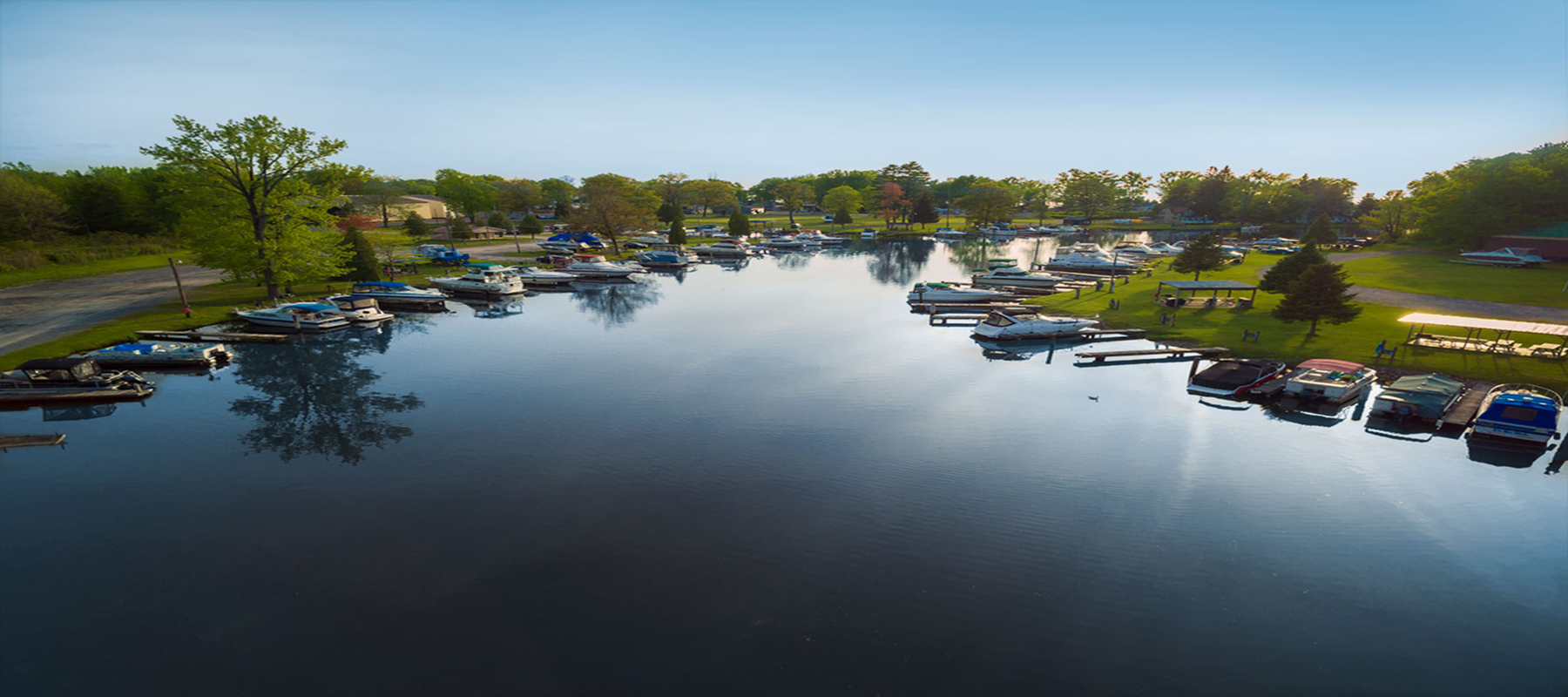 wide river with boats and trees along the exterior