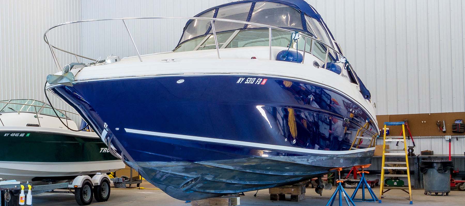 large blue boat in storage garage